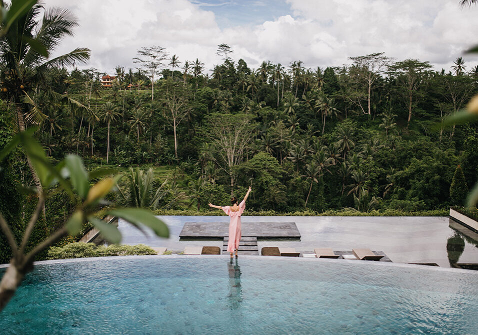 portrait-from-back-female-model-pink-dress-looking-rain-forest-outdoor-shot-graceful-woman-dancing-near-pool